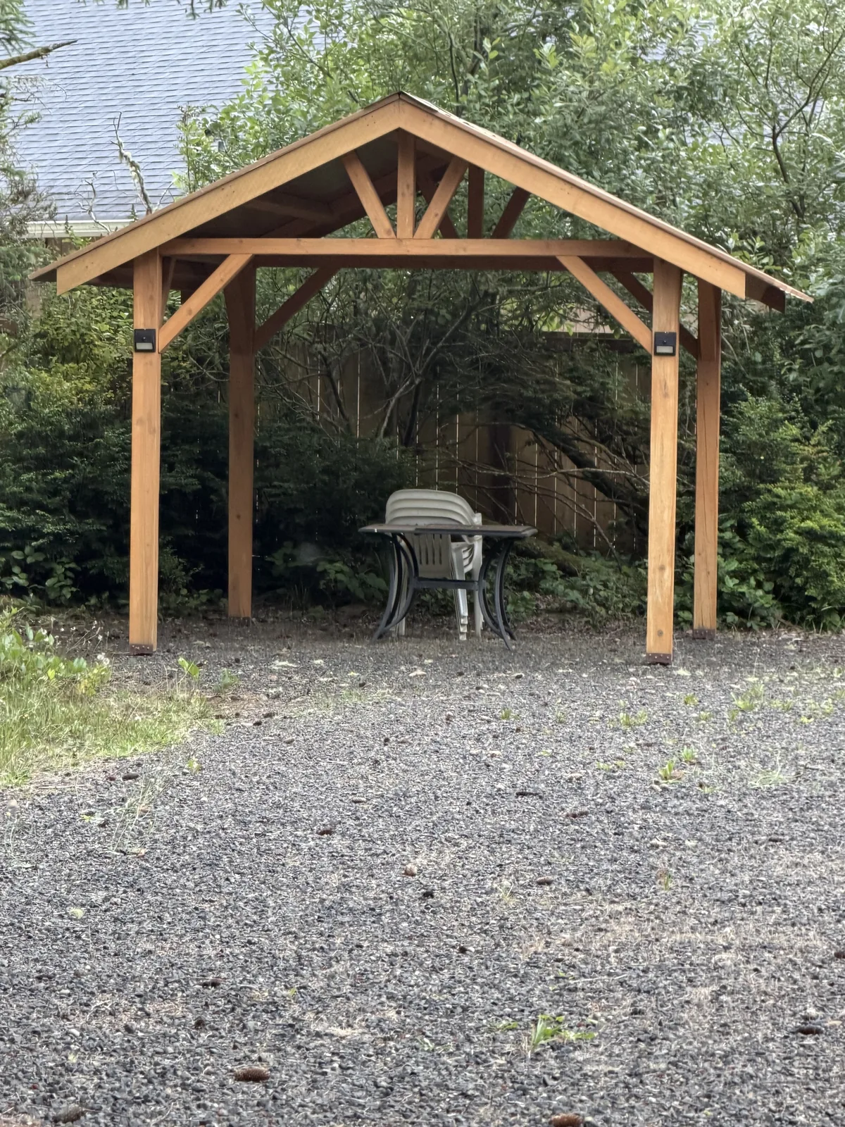Cedar post-and-beam gazebo built in a backyard