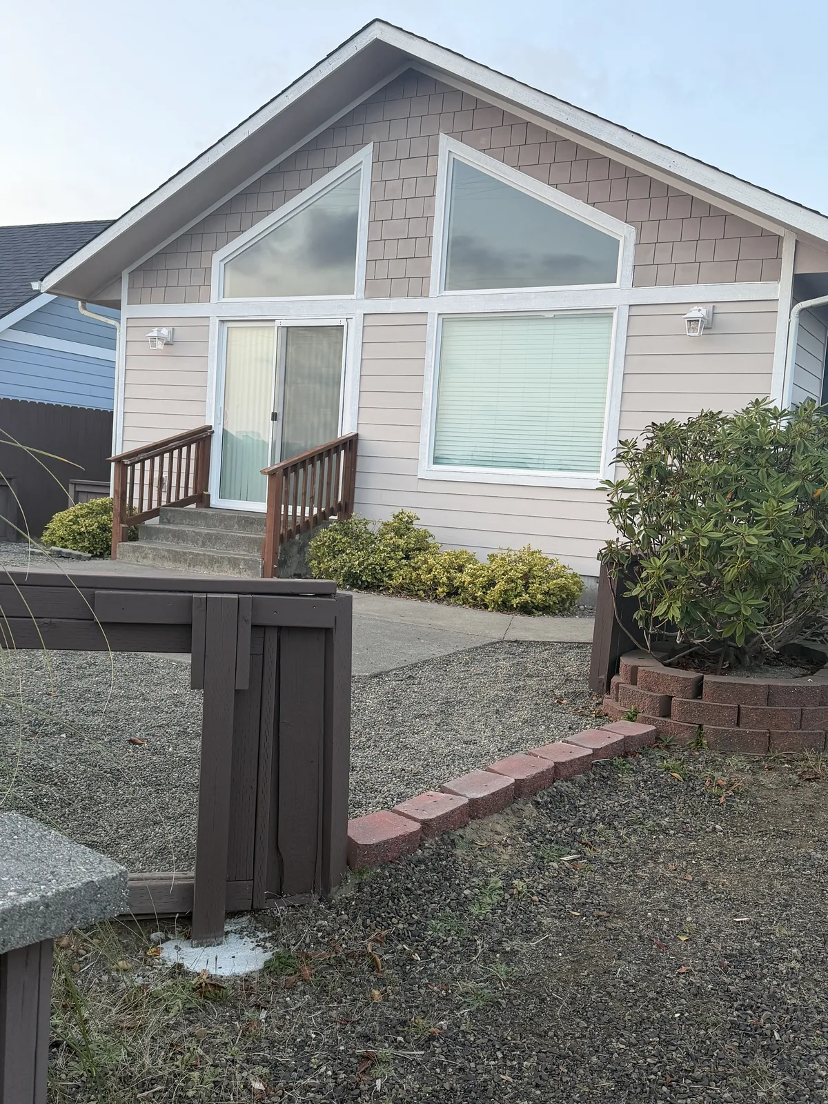 Home with newly installed shingle and lap siding, trimmed and finished